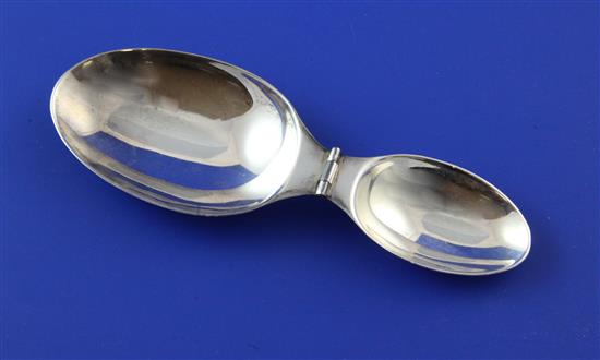 A 20th century Cartier sterling silver travelling double measure folding spoon, 5.25in (open).